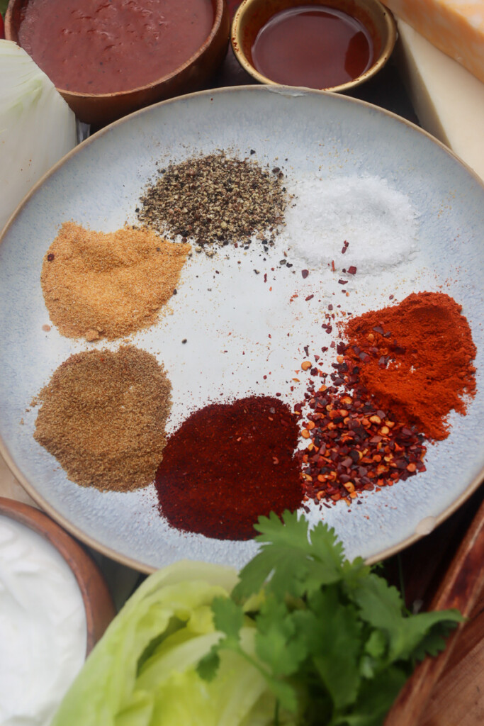 spices for fajita seasoning on a white plate