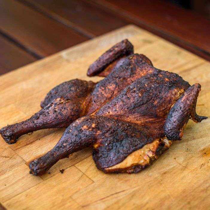 smoked-spatchcock-chicken-on-a-cutting-board