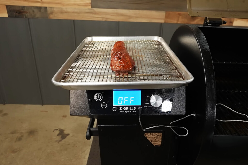 metal rack with smoked pork tenderloin on a Z Grills 7002c2ce pellet grill hopper