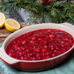 bowl of cranberry sauce with Christmas ornament in background