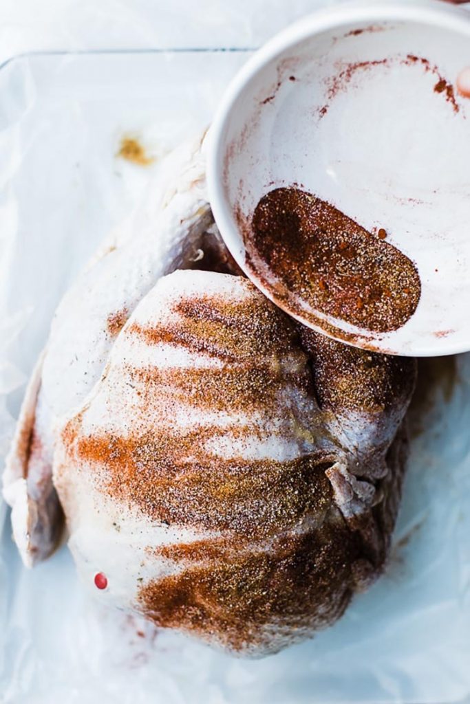 raw turkey with fried turkey rub applied