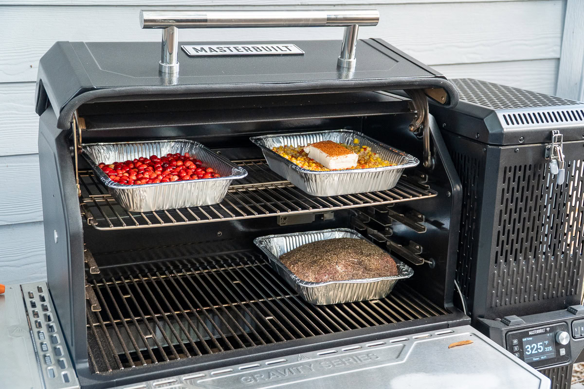 Various dishes smoking inside the Masterbuilt Gravity XT grill