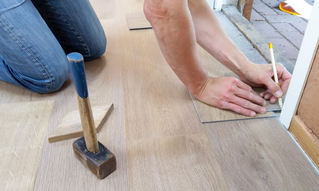 man taking measurements for flooring option