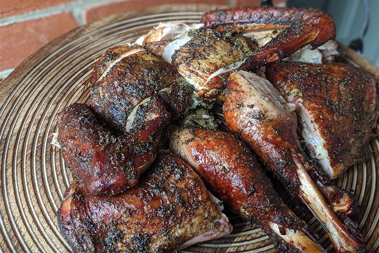 smoked spatchcocked turkey on a wooden board