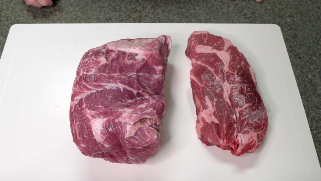 a piece of raw beef and pork on a white board