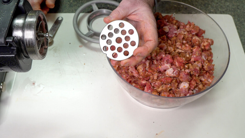 a hand holding a 10mm grinding plate