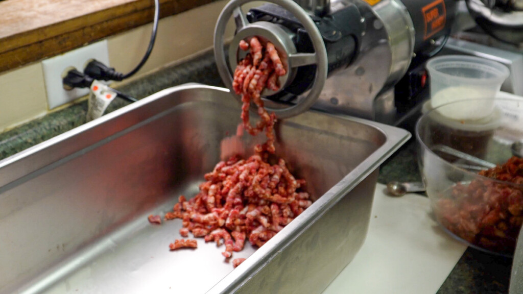 meat coming out of a grinder