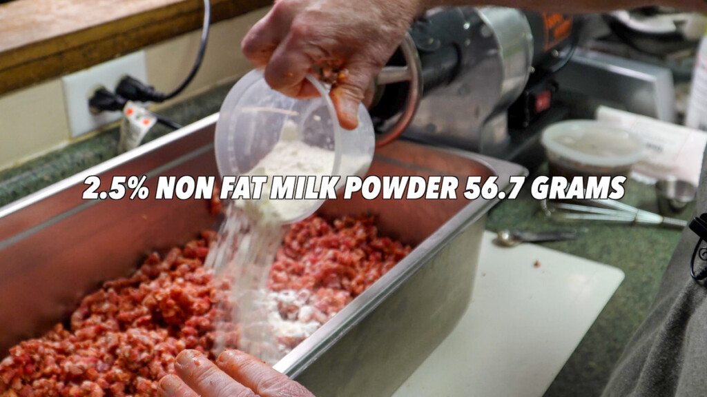 milk powder being sprinkled over raw meat hot guts