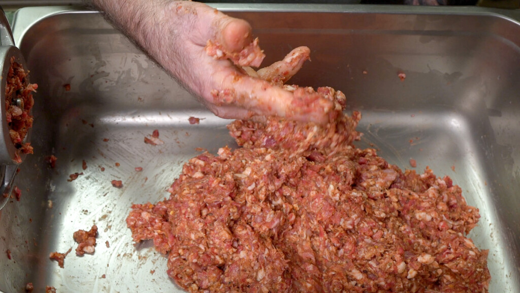 raw meat sticking to a hand