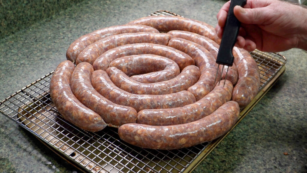 pricking raw sausage to remove air pockes