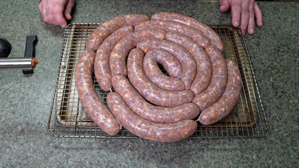 a coil of raw texas hot gut sausages ready for the fridge