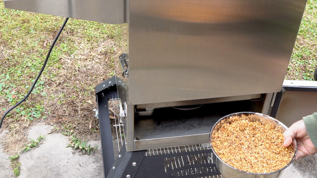 adding sawdust to the smoker