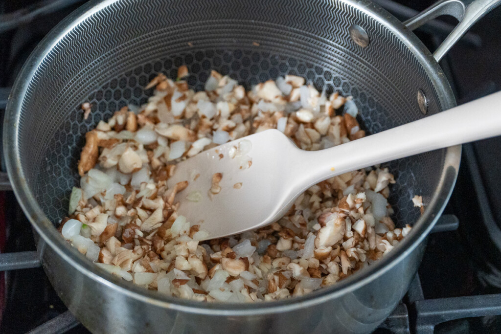 mushroom and onion suateeing in a pan