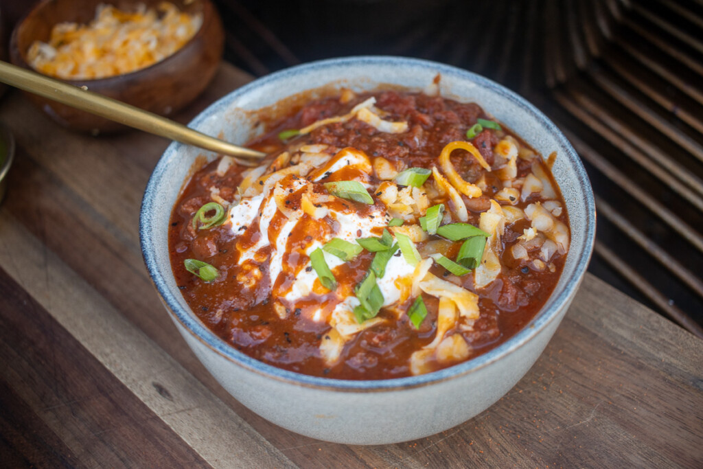 over the top chili in a bowl with all the toppings