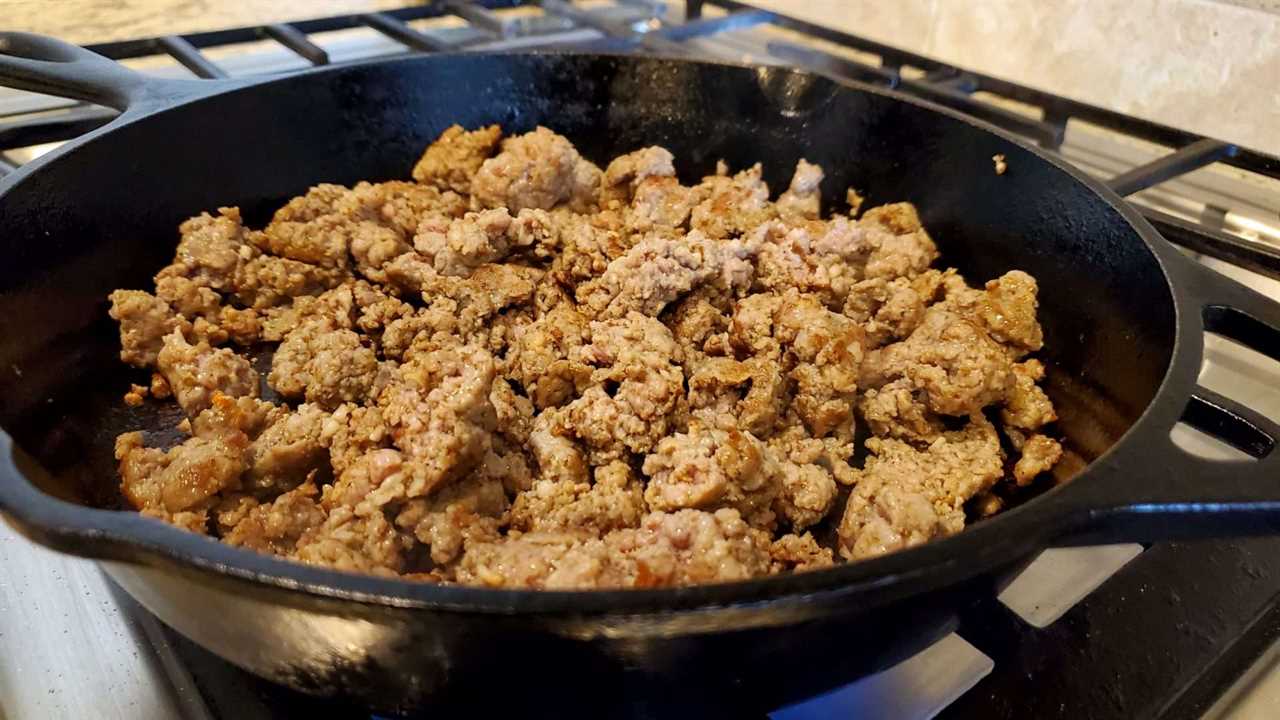 breakfast sausage cooking in a cast-iron pan.