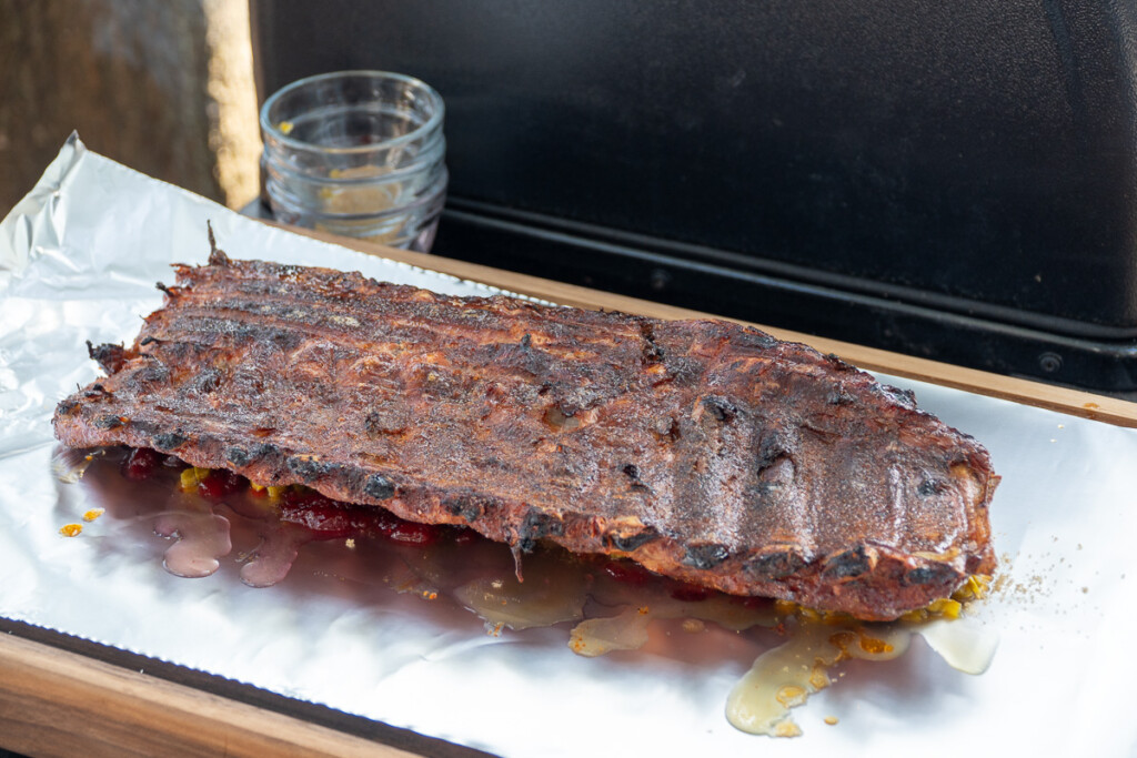 cooked ribs sitting on aluminum foil