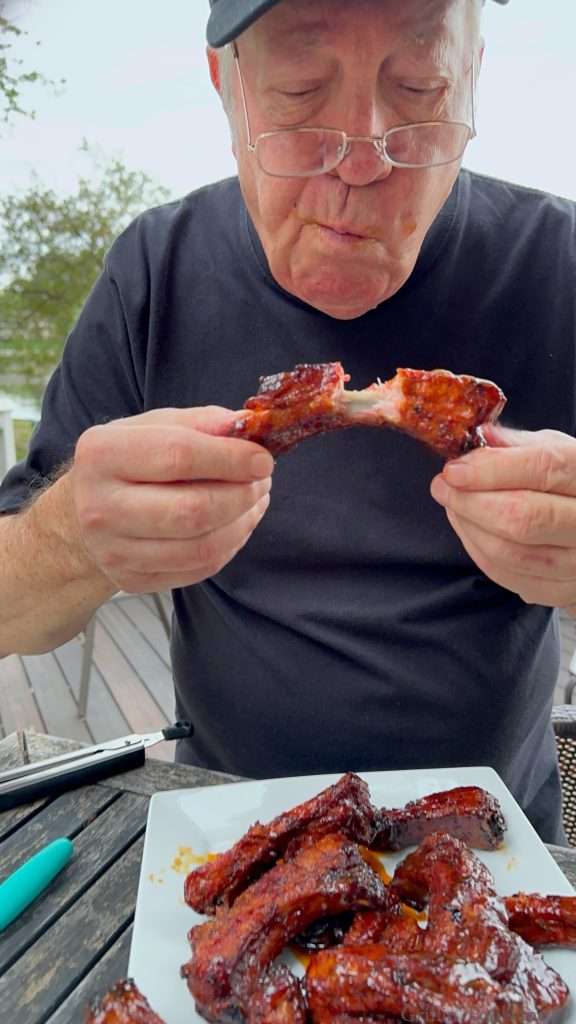 Dad taking a bite of ribs