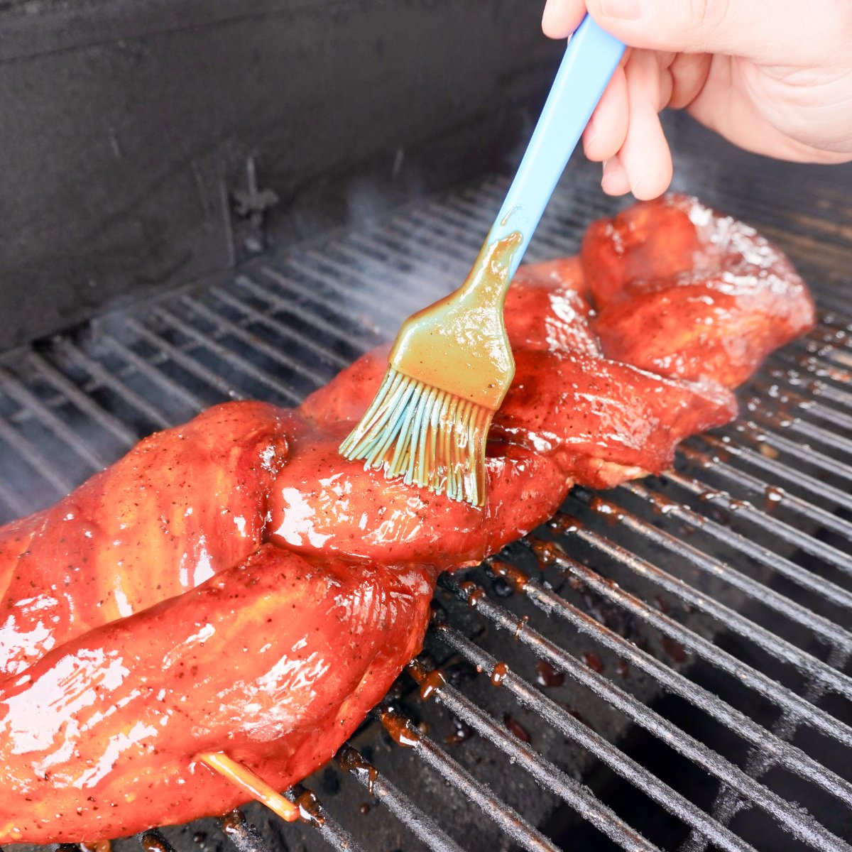 grilled pork on the grill and brushed with sauce.