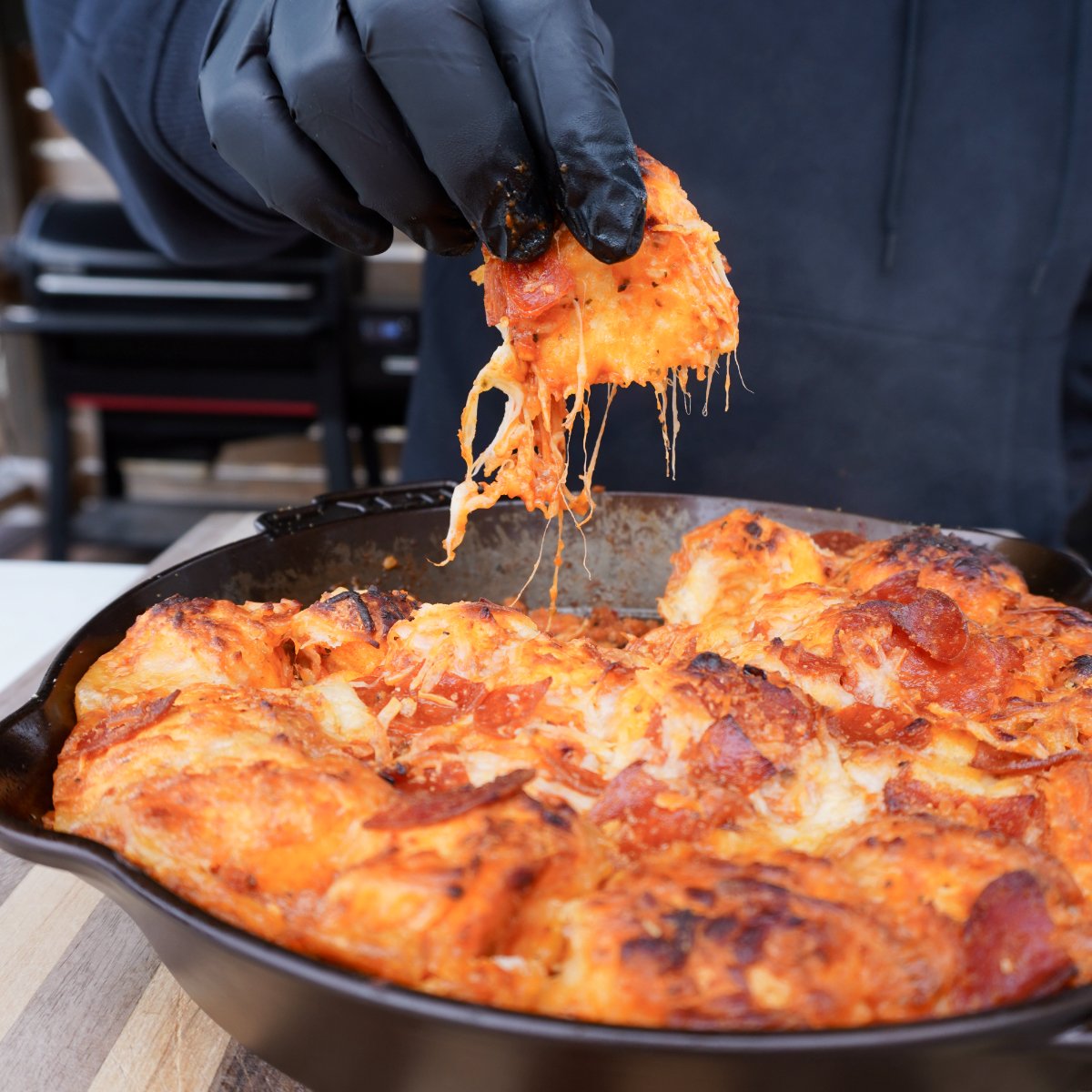 Individual cheesy and saucy biscuit pulled from the skillet.