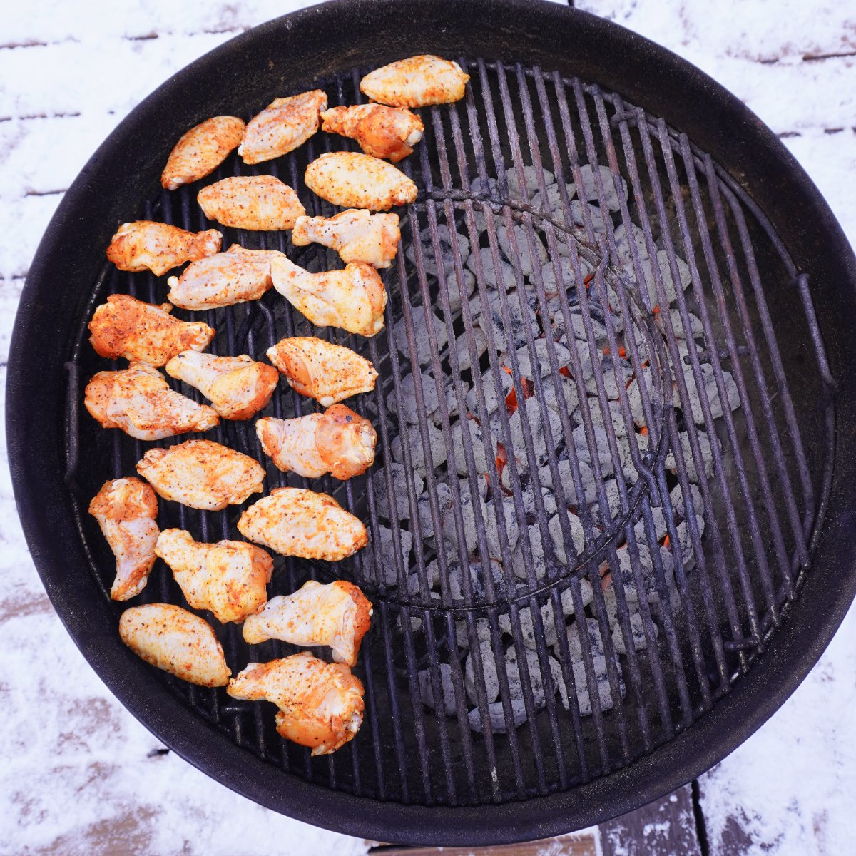 Seasoned wings on the indirect side of the grill.