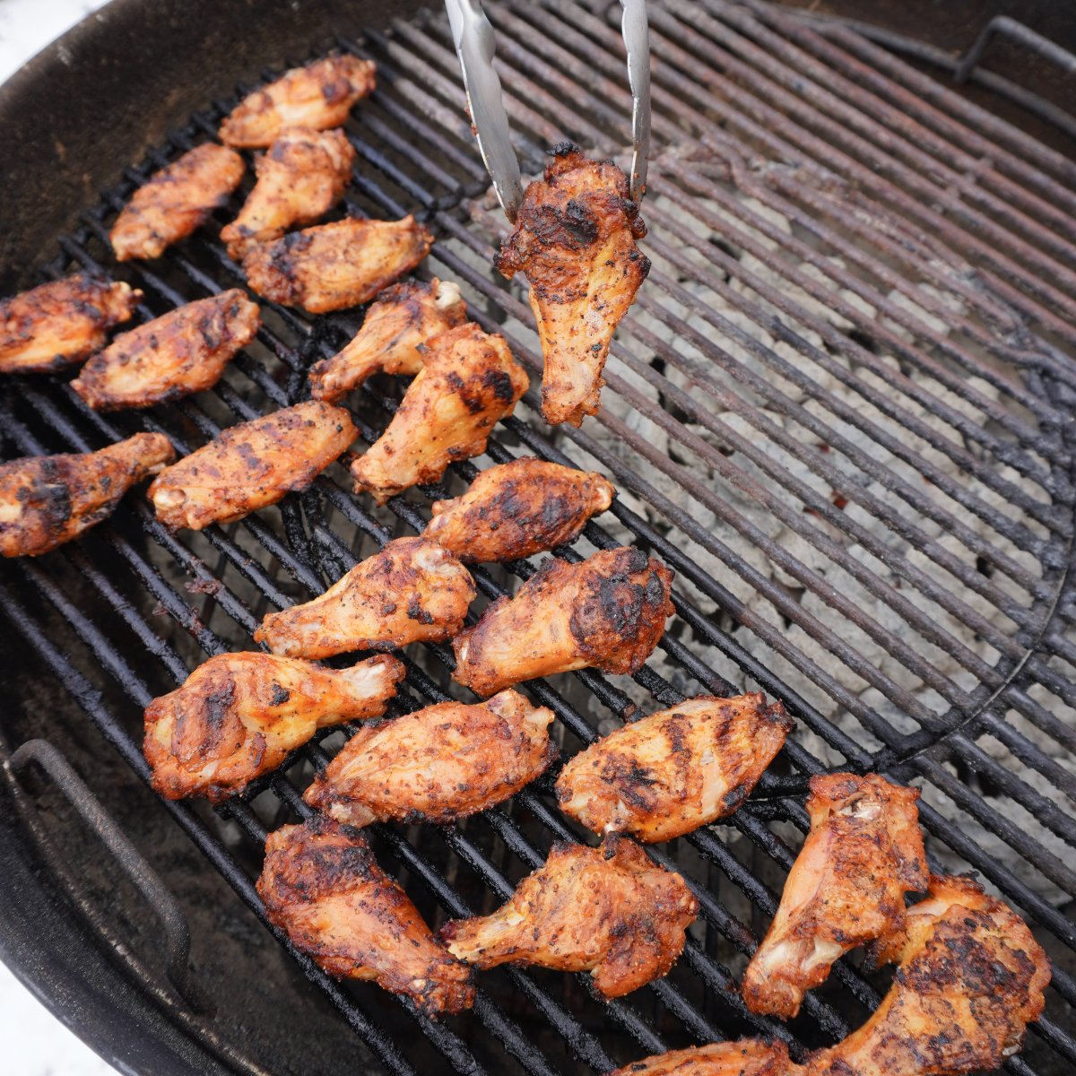 Moving wings to the direct side for the perfectly grilled chicken wings.