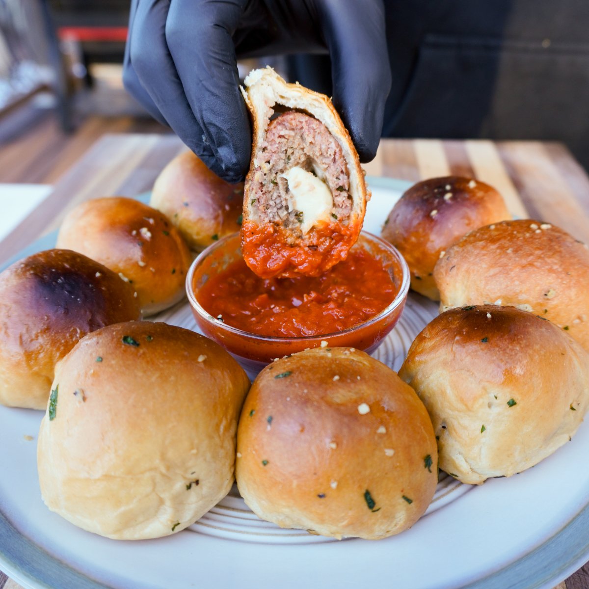 sliced smoked meatball biscuits dipped in marinara sauce.