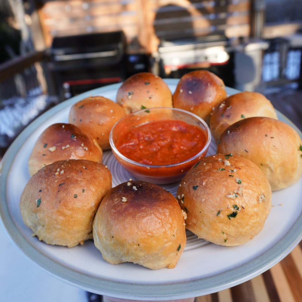 Smoked Meatball Biscuits served on a plate with marinara sauce in the middle