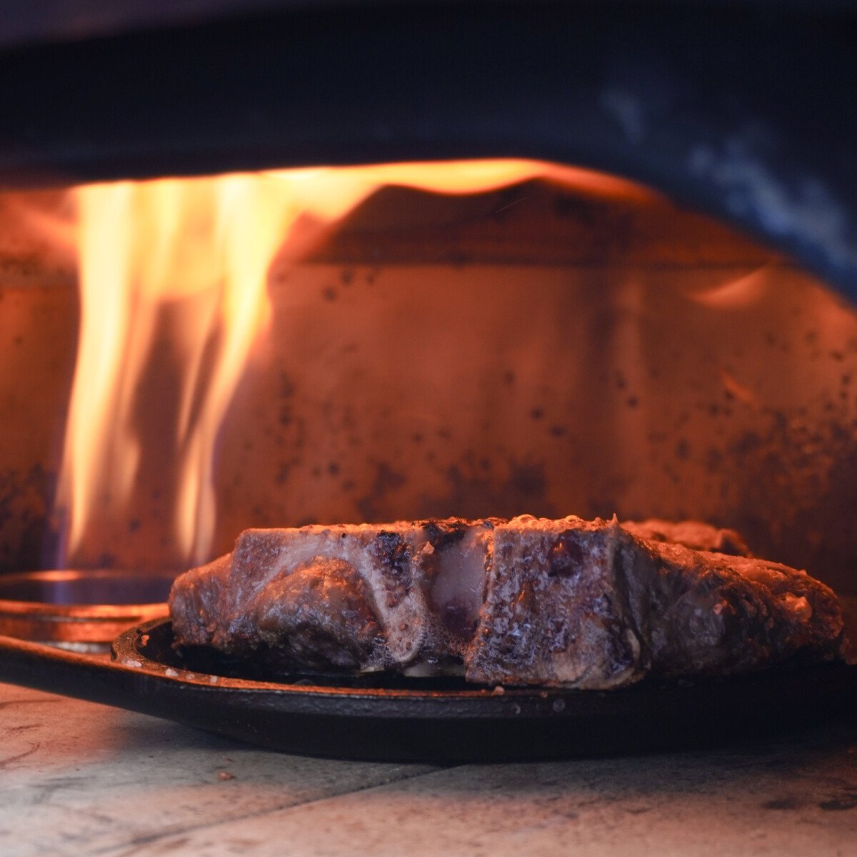 Porterhouse steak in the pizza oven.