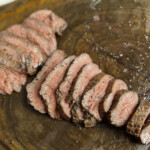 sliced smoked tri tip on butcher block