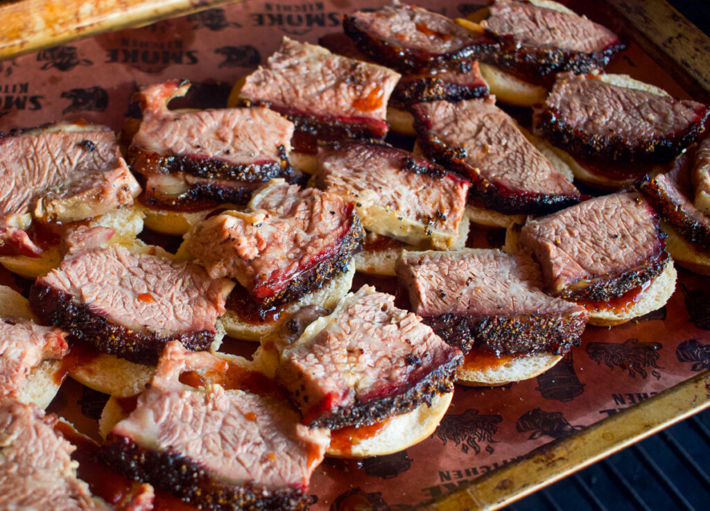 slider buns topped with slices of beef rib