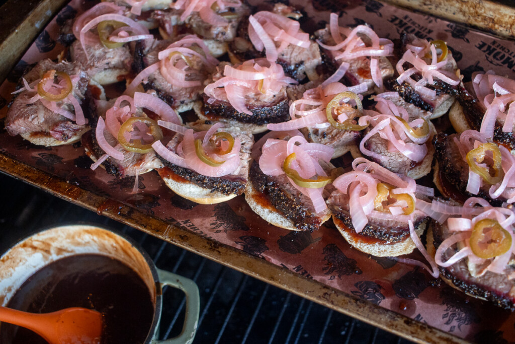 slider buns topped with prime rib and pickled onions