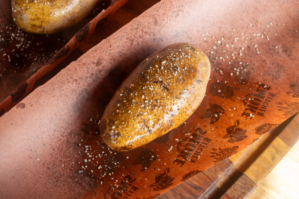 a seasoned raw potato on butcher paper