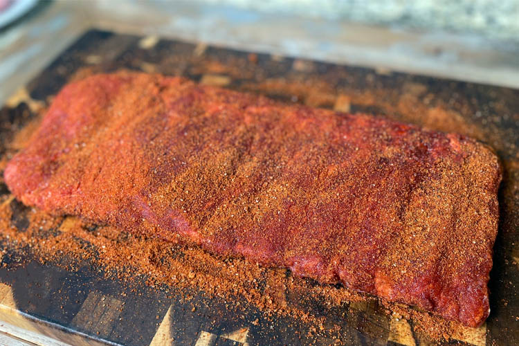 slab of raw pork ribs with rub