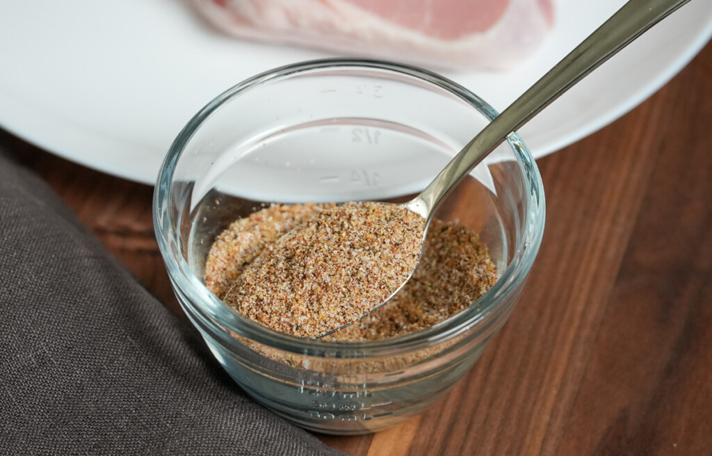 a bowl with pork seasoning and a spoon in it