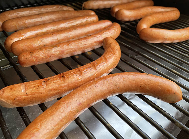 smoked homemade hotdogs on a smoker