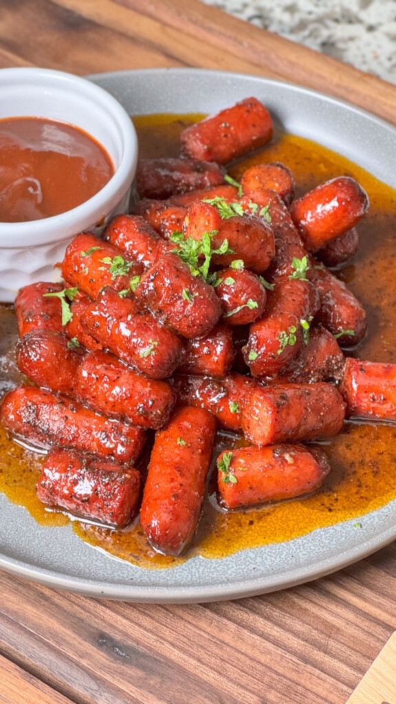 plate of hot dog burnt ends with dipping sauce