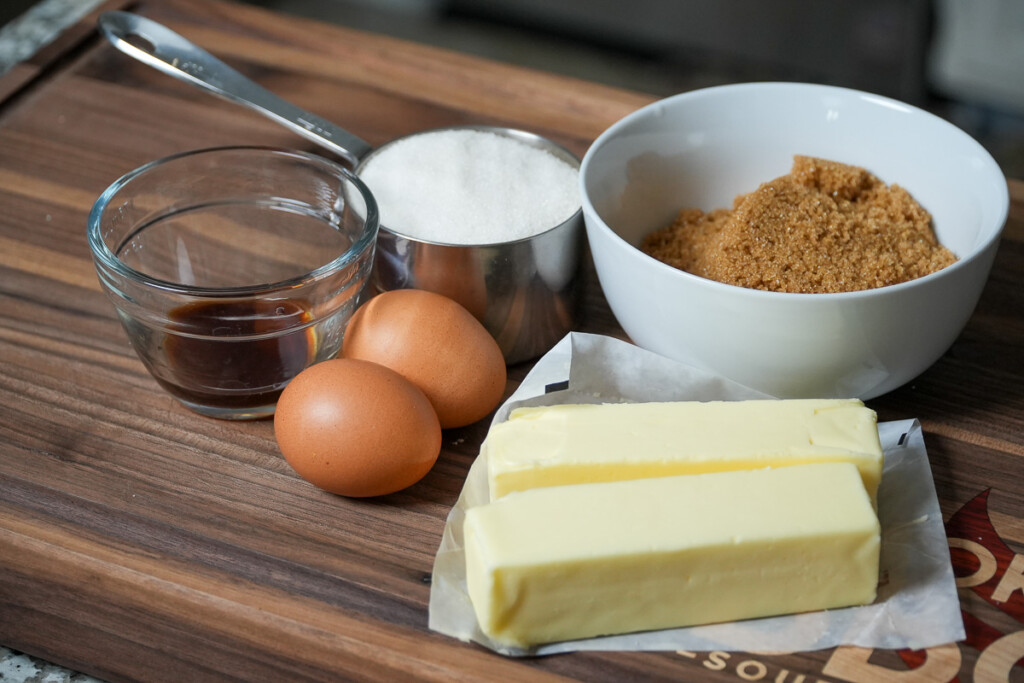 ingredients for chocolate chip cookies on a wooden board