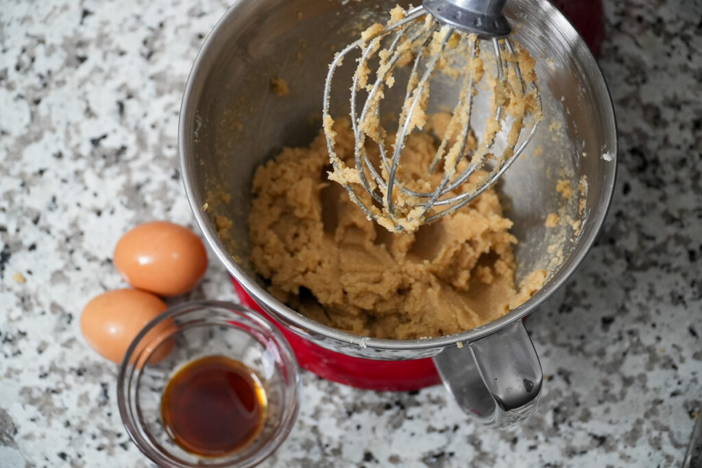 looking into a mixer bowl of raw cookie dough