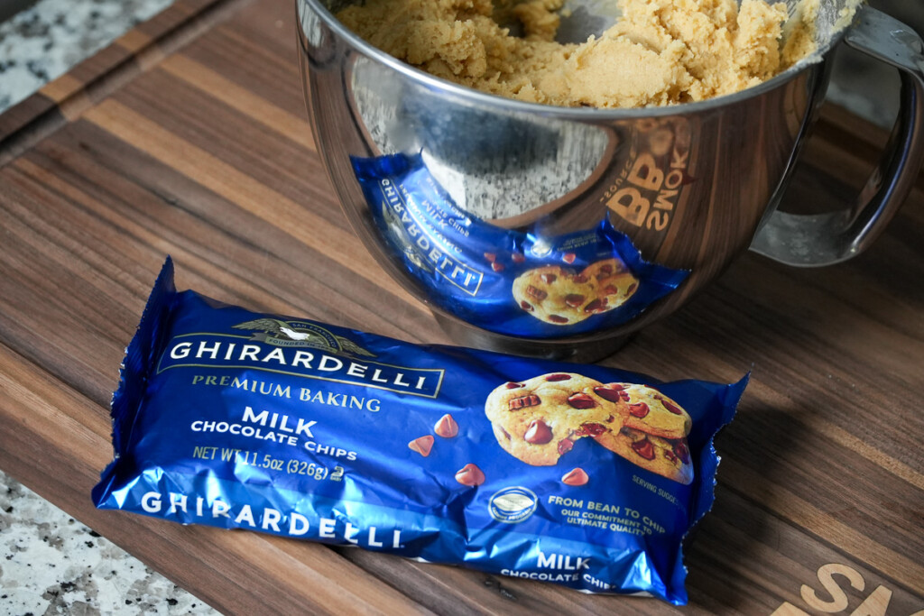 a bag of chocolate chips beside a mixing bowl