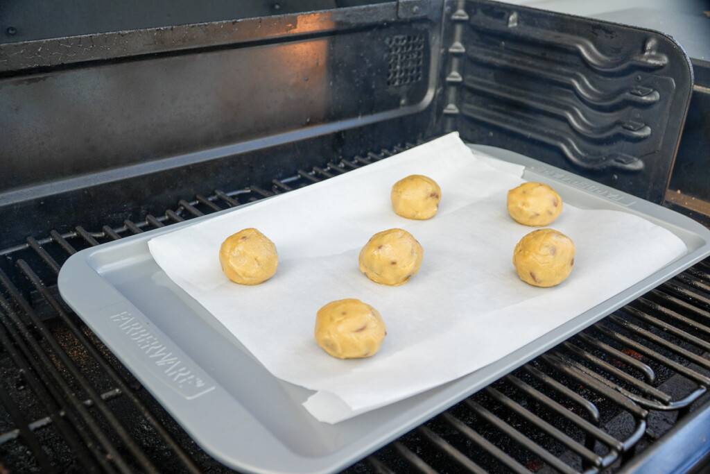 a sheet pan of raw cookie dough balls in the smoker