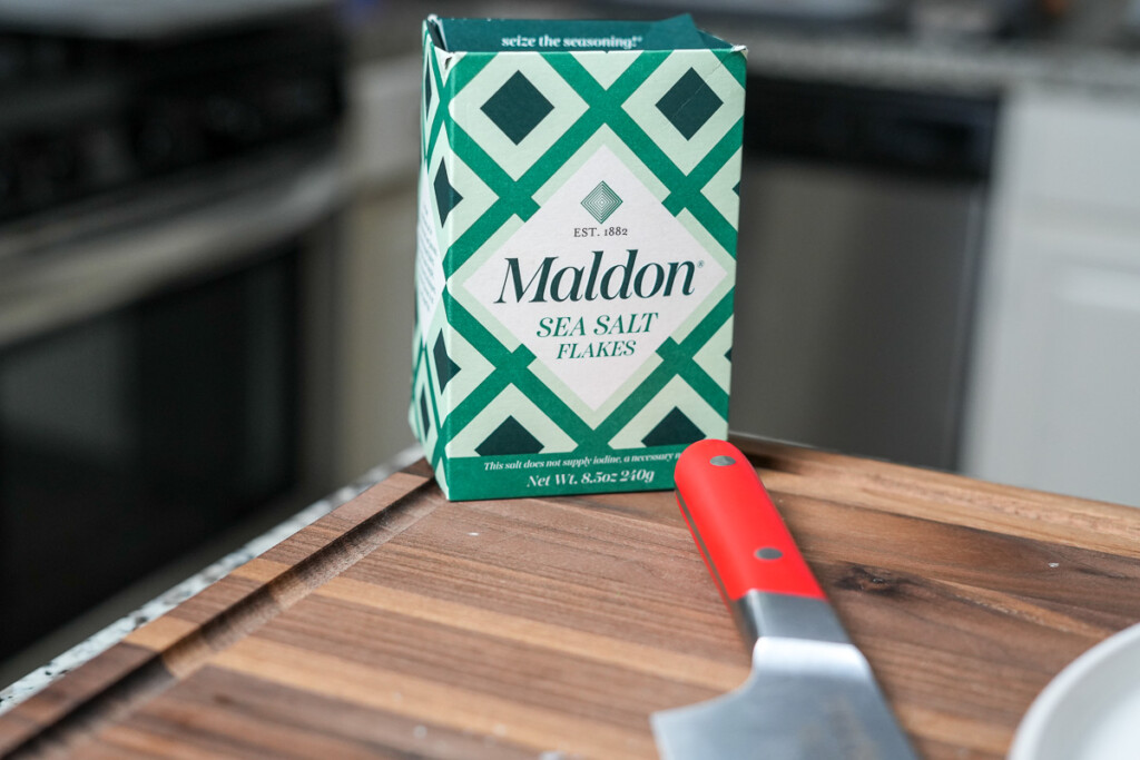 a box of maldon sea salt with a red handled knife