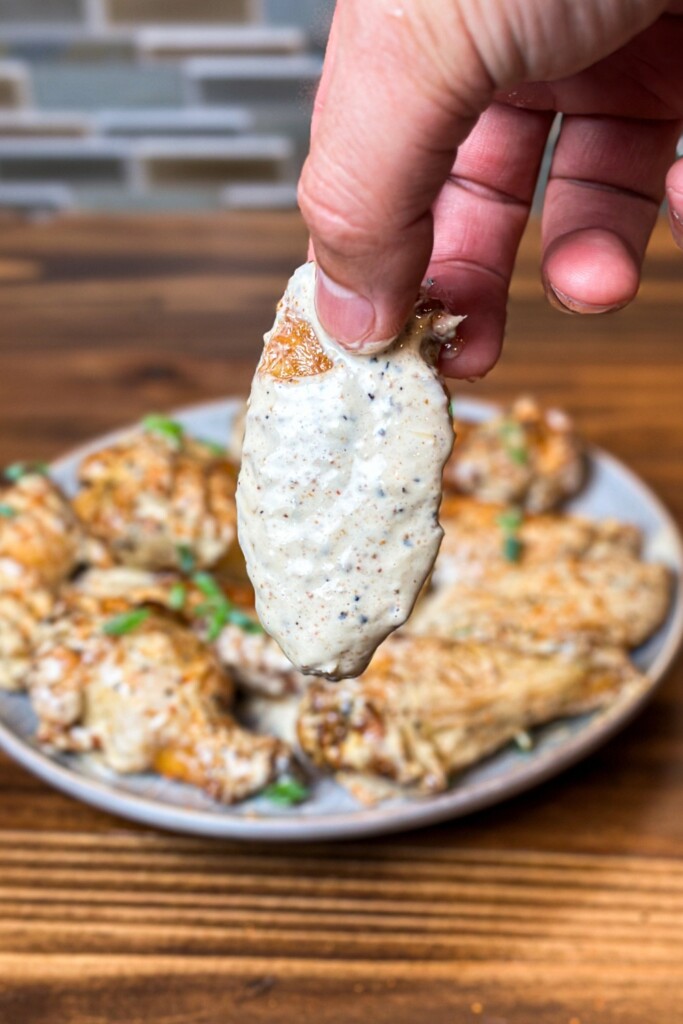 chicken wing covered in Alabama white sauce