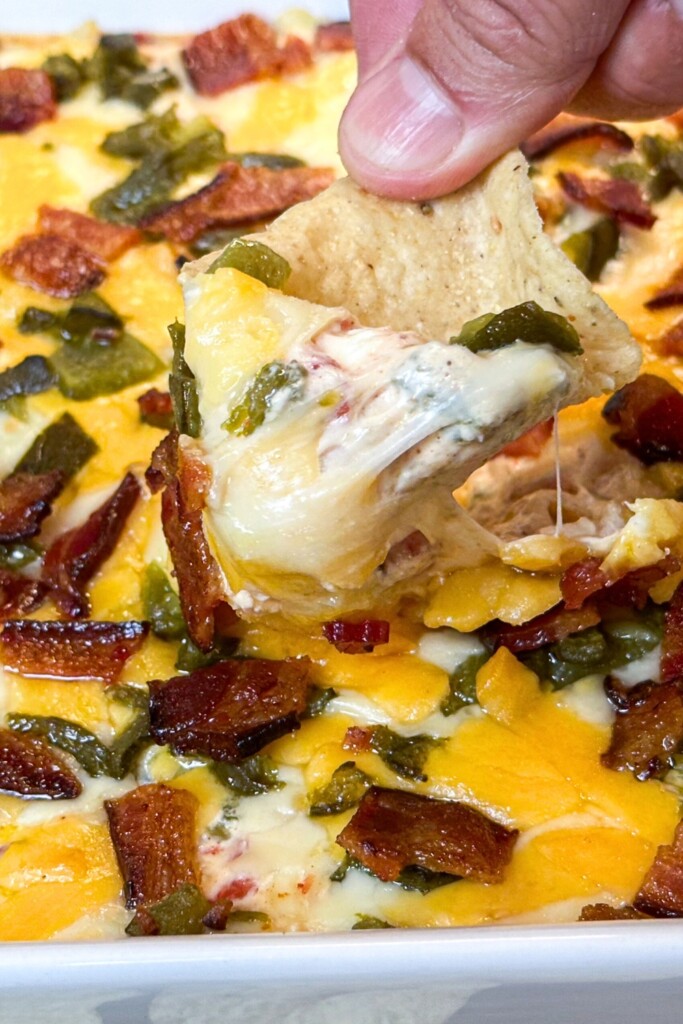 a nacho dip covered with smoked jalapeño popper dip