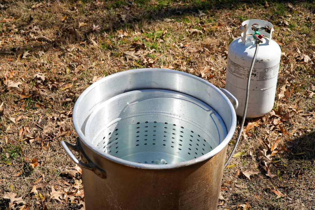 a large staineless stockpot with a strainer bucket inside