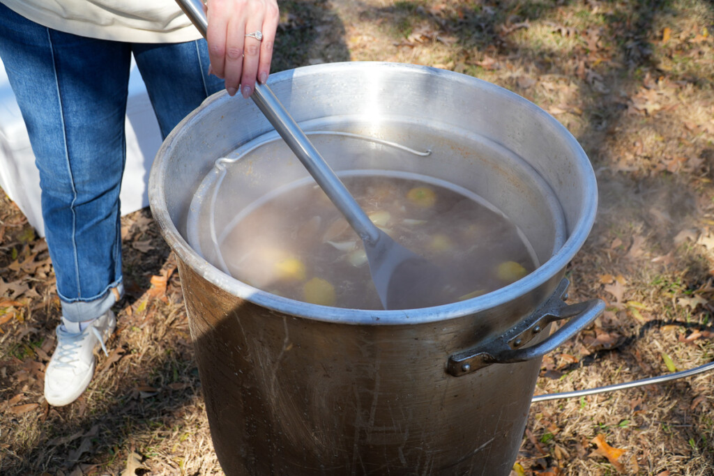 a women stirring the contents of a stockpot