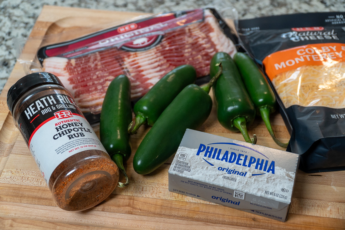 ingredients for smoked jalapeno poppers on a wooden board