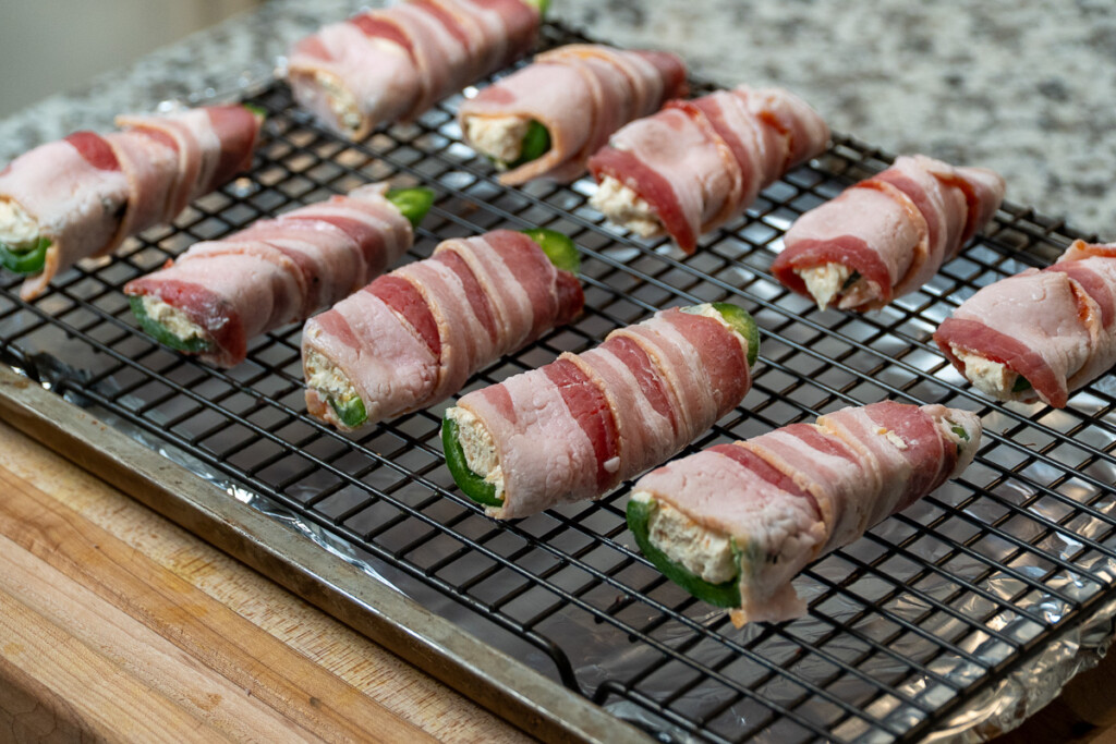 raw jalapeno poppers on a wire rack