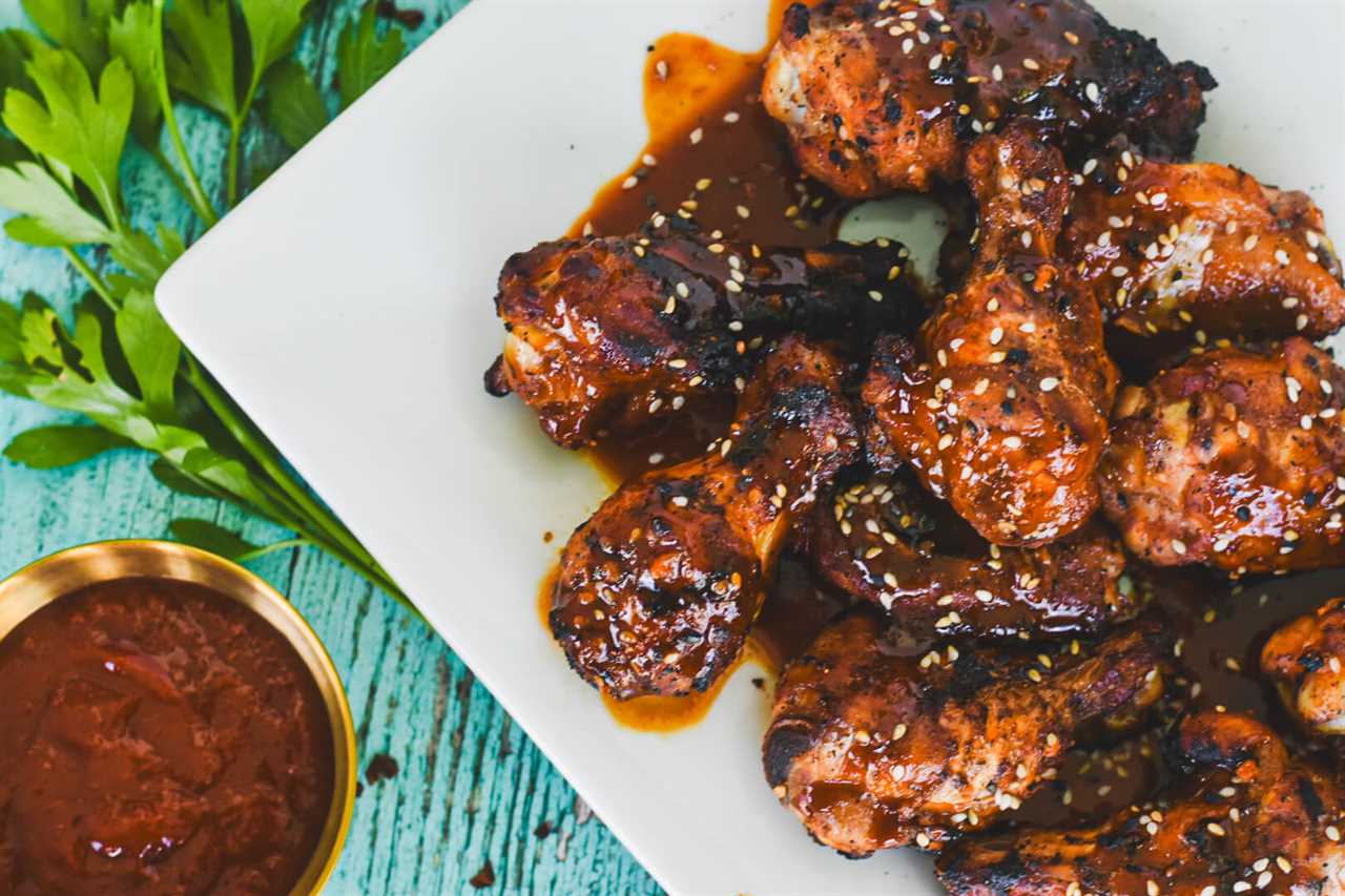 A platter of gochujang chicken wings topped with sesame seeds. 