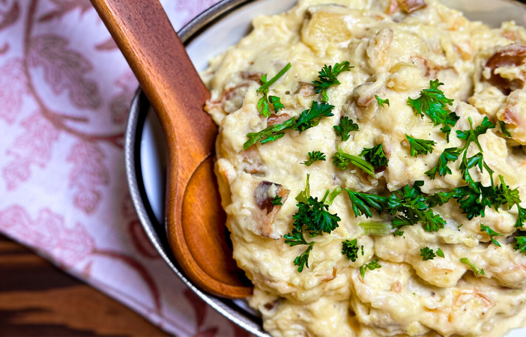 smoked garlic mashed potatoes plated with a wooden serving spoon