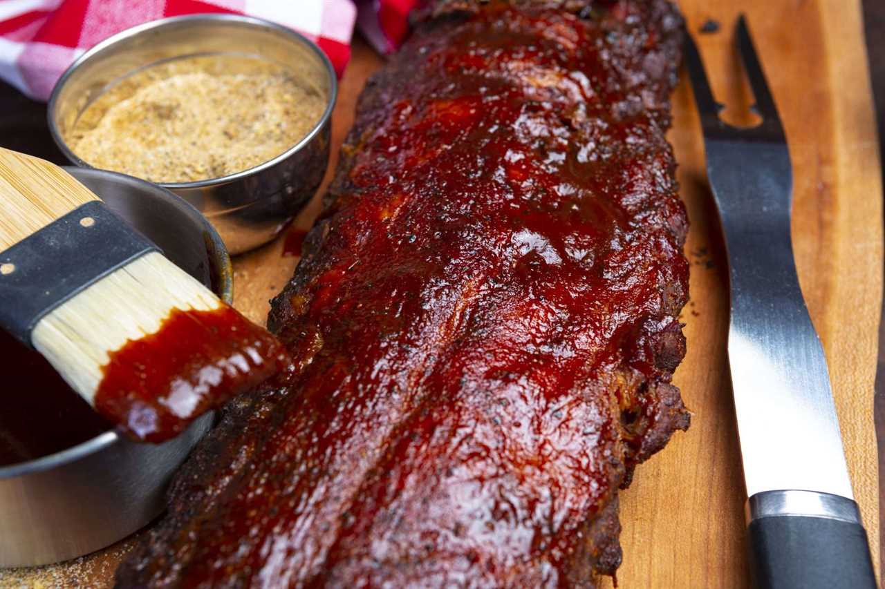 KC BBQ sauce on brush with rack of ribs